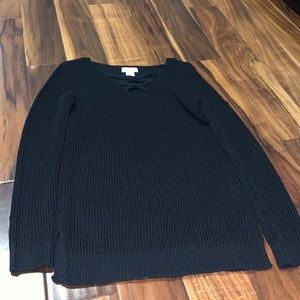 Black sweater crosses in the front